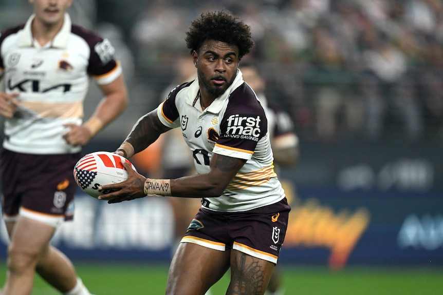 Brisbane Broncos' Ezra Mam runs with the ball in the NRL season opener in Las Vegas against the Sydney Roosters.