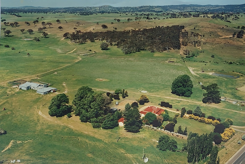 An aerial view of the roof of a homestead in the middle of a field.