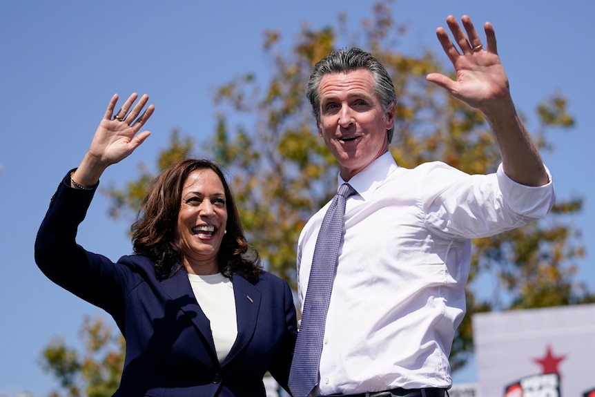 Vice President Kamala Harris waves with California Gov. Gavin Newsom 