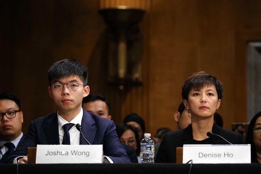 Denise Ho and Joshua Wong sitting in a congressional hearing in Washington.