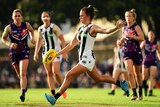 Chloe Molloy kicks the ball during a game against Fremantle at Fremantle Oval