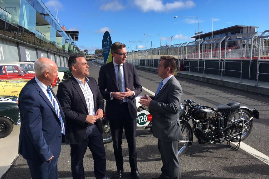 Bathurst's mayor Graeme Hanger and NSW Government frontbenchers discuss an expansion of Mount Panorama at the pit lane.