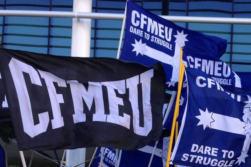 CFMEU flags waving.