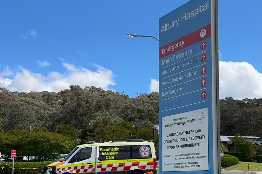 An ambulance drives out of Albury hospital site. 