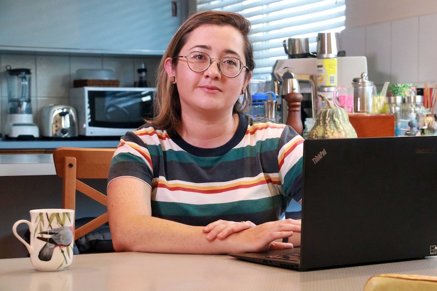 Beth Wright sits in front of a lap top computer.