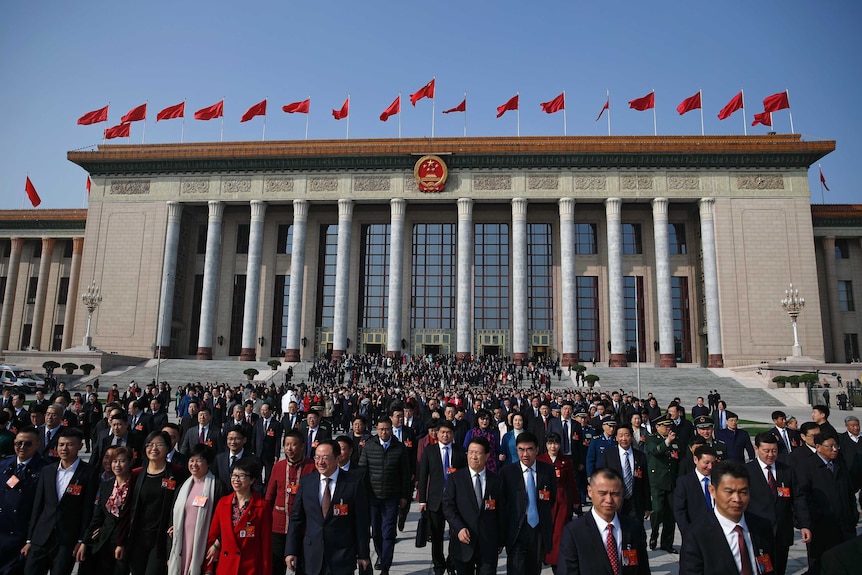 Delegates leave the Great Hall of the People after attending a meeting of the NPC in China.