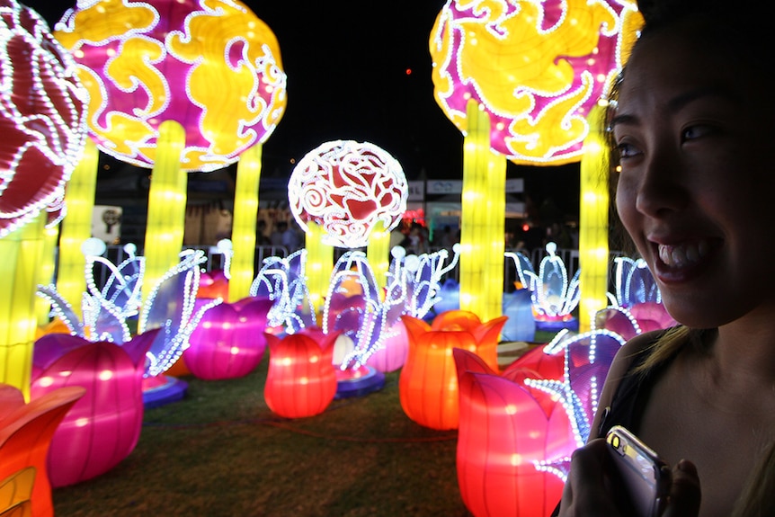 Woman's silhouette in front of a display of Chinese lanterns