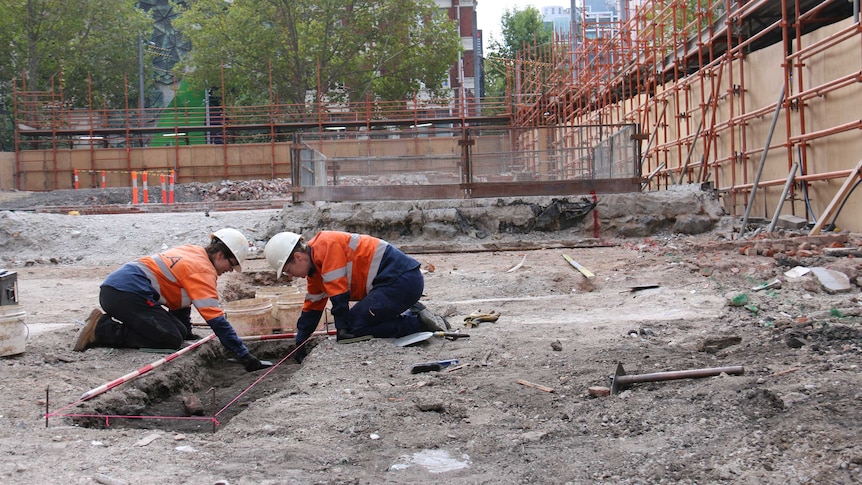 Workers at an archaeological dig site on the corner of La Trobe St and Swanston St.