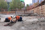 Workers at an archaeological dig site on the corner of La Trobe St and Swanston St.