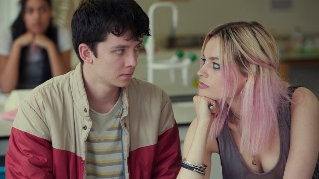 A still from a Netflix show features two teenagers looking at each-other