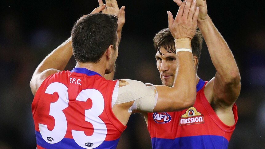 The Western Bulldogs' Nick Lower (L) celebrates Koby Stevens' goal against Hawthorn at Docklands.