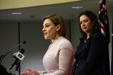 Queensland Treasurer Jackie Trad speaks to the media in the budget lock-up, with Premier Annastacia Palaszczuk in background.