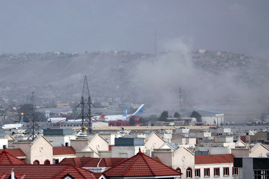 Smoke rises from a deadly explosion outside the airport in Kabul