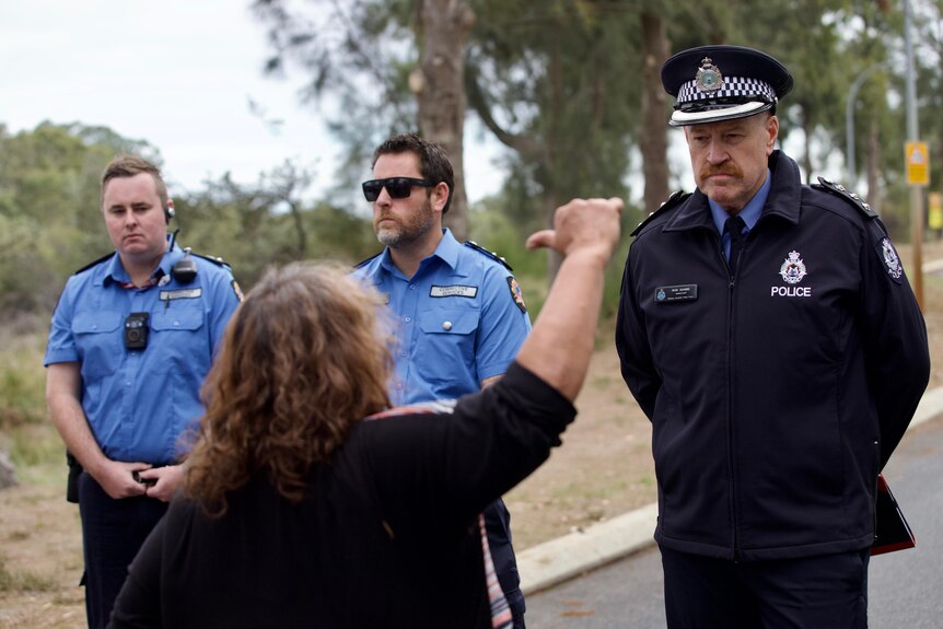 A protester gives police the thumbs down at a rally at Banksia Hill detention centre.