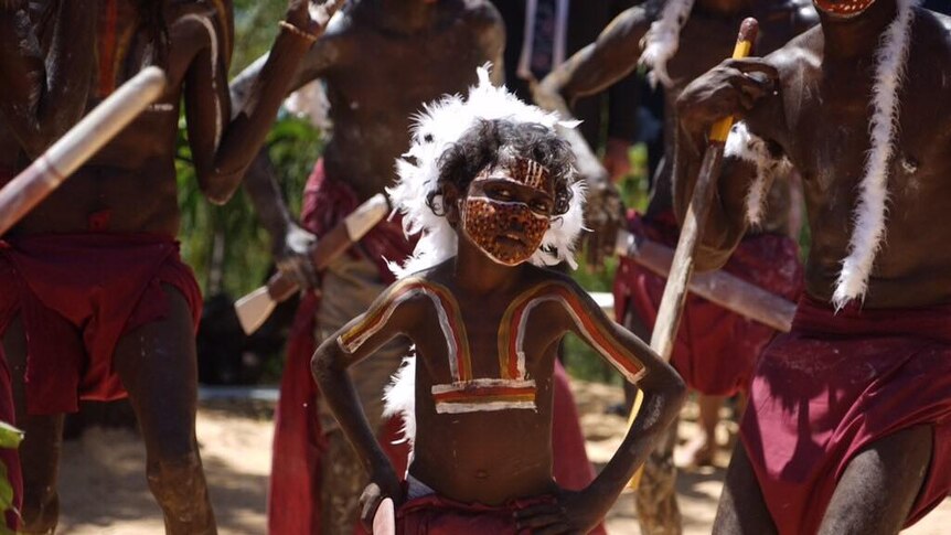 Traditional owners wearing ochre paint perform for Prince Charles.