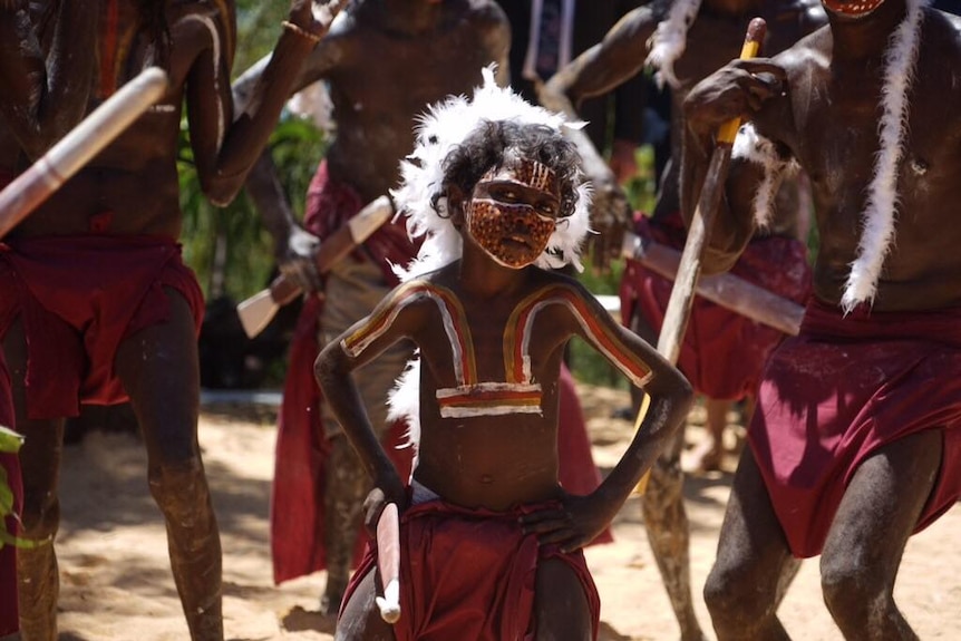 Traditional owners wearing ochre paint perform for Prince Charles.