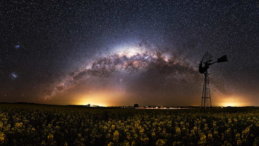 Arch of stars over windmill and crops