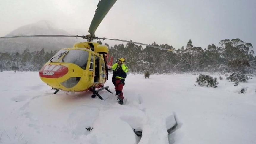 Tasmania's rescue helicopter lands in snow on the Overland Track.