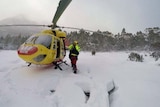 Tasmania's rescue helicopter lands in snow on the Overland Track.