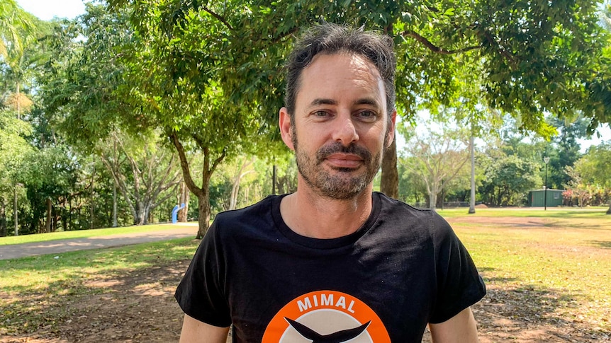 Dominic Nicholls wearing a Mimal rangers t-shirt, standing in a park.