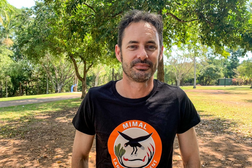 Dominic Nicholls wearing a Mimal rangers t-shirt, standing in a park.