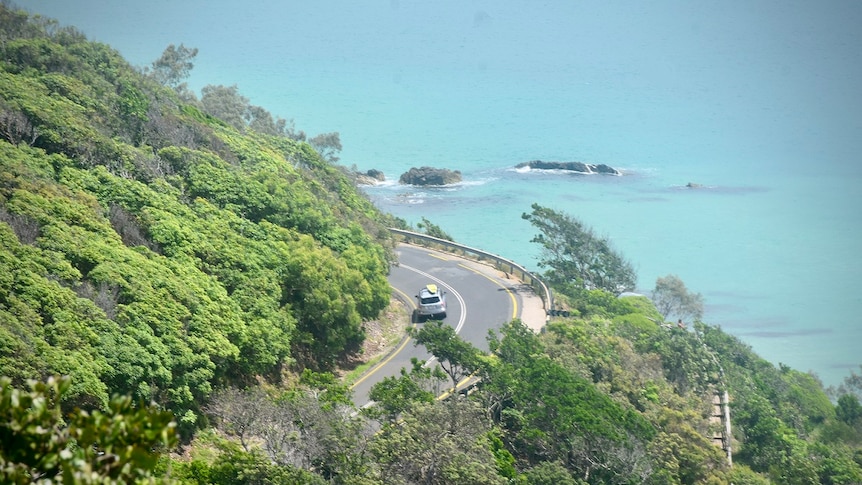 A car driving down from the lighthouse in Byron Bay.
