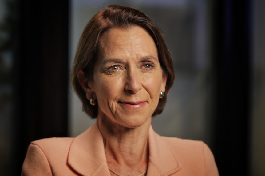 Jayne Hrdlicka wearing a blazer looking at an interviewer.