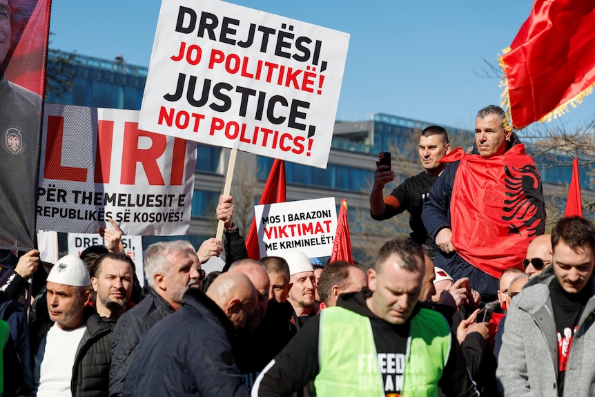 Supporters of former Kosovo President Hashim Thaci protest on the first day of his war crimes trial.