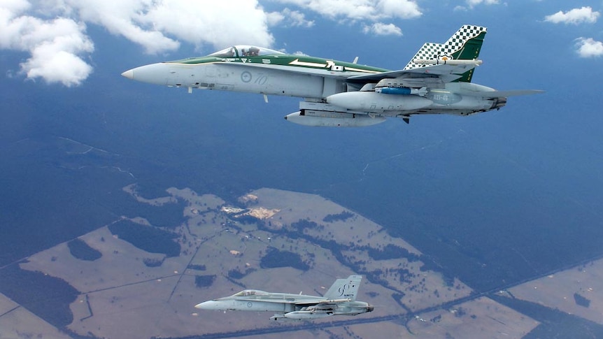 Two F/A-18A's fly over the Australian International Airshow.