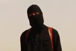 'Jihadi John' stands masked next to James Foley while holding a knife