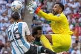 Goalkeeper Mohammed Al-Owais leaps and knees Saudi Arabia temmate Yasser Al-Shahrani in the face at the World Cup.