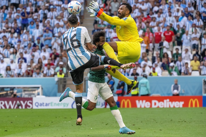 Goalkeeper Mohammed Al-Owais leaps and knees Saudi Arabia temmate Yasser Al-Shahrani in the face at the World Cup.