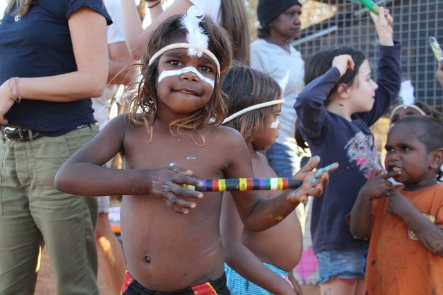 An Aboriginal child with face paint. 
