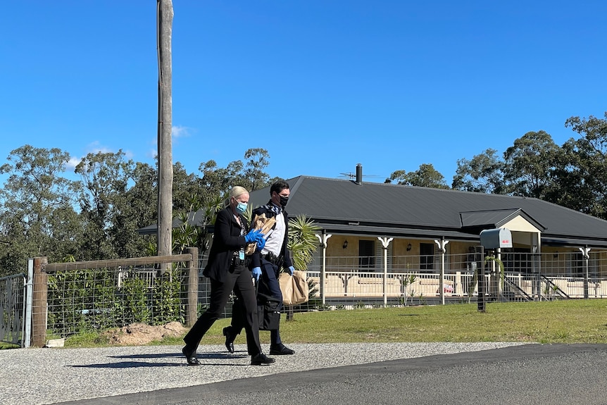 Police leave a home where a man was arrested.