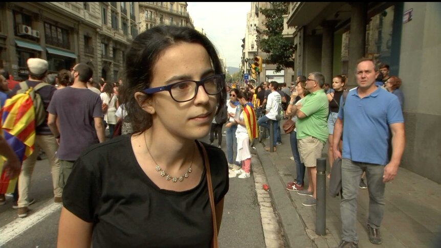 A young woman takes part in protests in Barcelona over the police handling of the Catalonia independence vote.