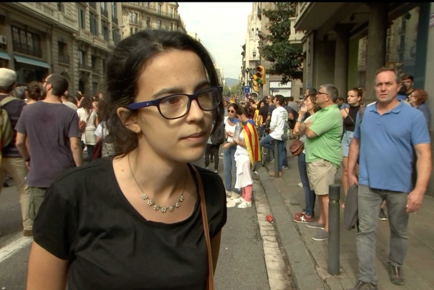 A young woman takes part in protests in Barcelona over the police handling of the Catalonia independence vote.