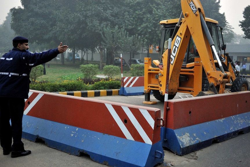 Bulldozer removes a barricade in front of US embassy in New Delhi