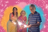 Vidya Rajan wearing a yellow saree, with her parents, all holding sparklers and celebrating Diwali in Western Australia.