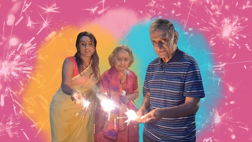 Vidya Rajan wearing a yellow saree, with her parents, all holding sparklers and celebrating Diwali in Western Australia.