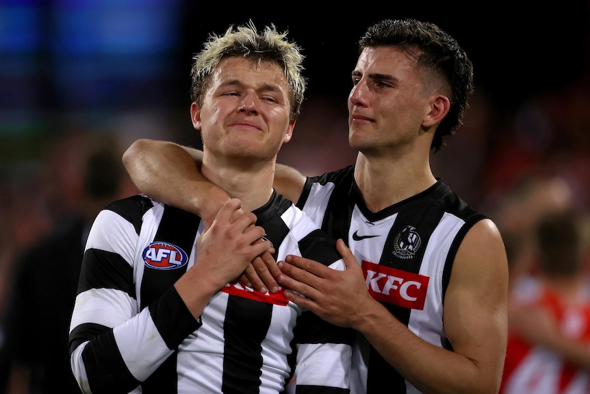 Nick Daicos puts his arm around Jack Ginnivan as they both cry