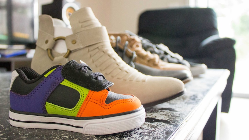 A row of shoes on a coffee table