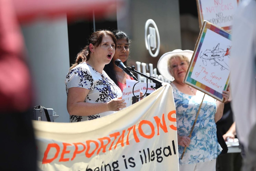 A womans speaks at a protest outside the Qantas AGM in Brisbane.