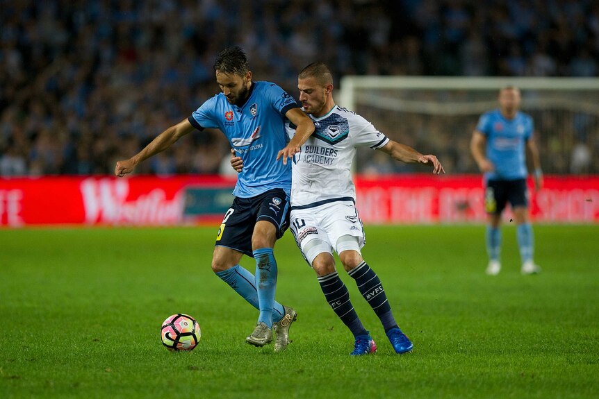 Milos Ninkovic and James Troisi battle for the ball