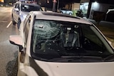 The broken windscreen of a car.