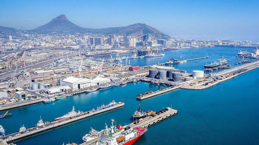 An aerial photo shows the Port of Cape Town in the foreground, and the city stretching to the mountains behind it.