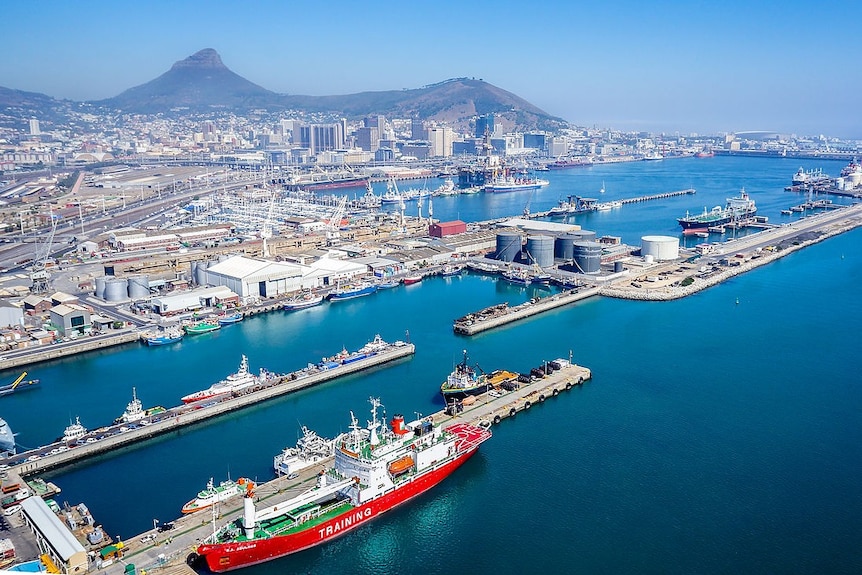 An aerial photo shows the Port of Cape Town in the foreground, and the city stretching to the mountains behind it.