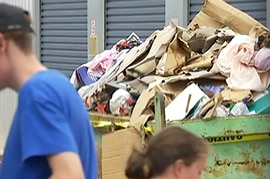 A skip bin full of flood damaged belongings at the National Storage facility in Fairfield.