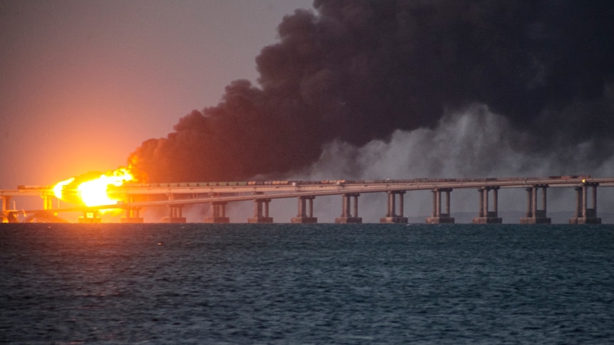 Fire and a plume of smoke on the bridge.