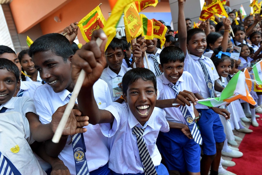 Sri Lankan school children cheer at re-opened rail link