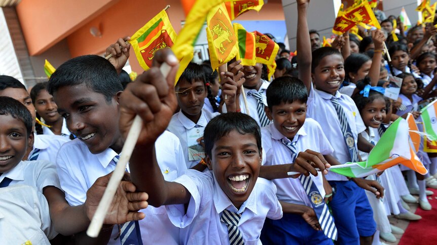 Sri Lankan school children cheer at re-opened rail link